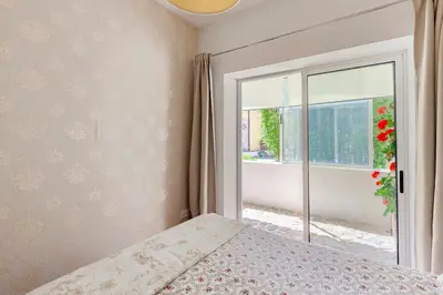 a bedroom with a bed and a large window at Stunning Designer Flat with Balcony Heart of Porto in Porto
