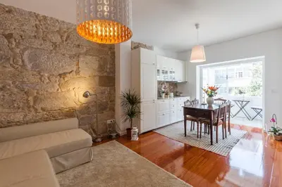a living room with a table and a dining room at Stunning Designer Flat with Balcony Heart of Porto in Porto