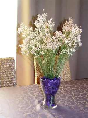 a purple vase with flowers in it on a table at Modern and quiet T1 with private Garage in Porto