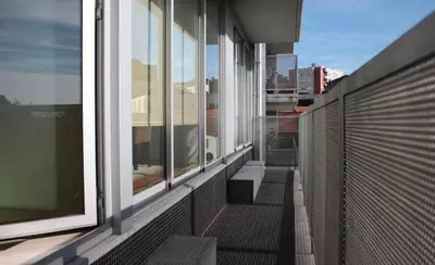 an empty balcony with windows on a building at Modern and quiet T1 with private Garage in Porto