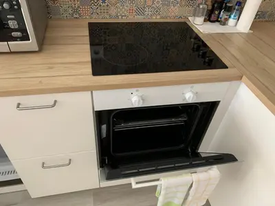 a kitchen with a black oven in a counter at Sweet apartment in Porto in Porto
