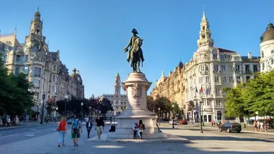 a statue in the middle of a street with buildings at Oporto Hideaway 3 - Poveiros Square Balcony in Porto