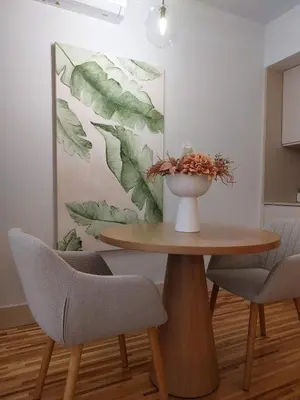 a table with two chairs and a vase with leaves on the wall at Oporto Hideaway 3 - Poveiros Square Balcony in Porto