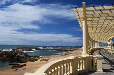 a building on a beach with a view of the ocean at Oporto Hideaway 3 - Poveiros Square Balcony in Porto