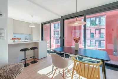a kitchen and dining room with a table and chairs at Stylish Open-Plan Flat with Swimming Pool by HostWise in Porto