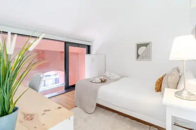 a living room with a couch and a table at Stylish Open-Plan Flat with Swimming Pool by HostWise in Porto