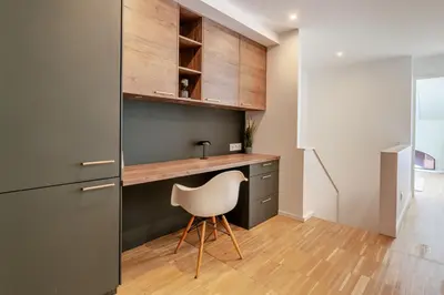 a kitchen with a sink and a chair in a room at Stylish Open-Plan Flat with Swimming Pool by HostWise in Porto