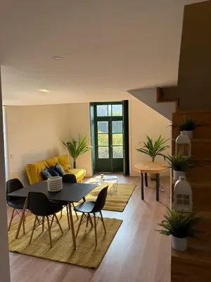 a living room with a table and a yellow couch at Douro Villa 2 -Best View in Town in Vila Nova de Gaia