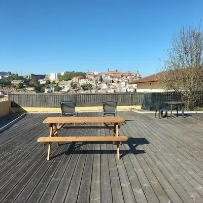 a wooden picnic table and two chairs on a deck at Douro Villa 2 -Best View in Town in Vila Nova de Gaia