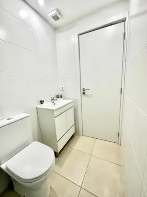 a white bathroom with a toilet and a sink at Douro Villa 3 - Best View in Town in Vila Nova de Gaia