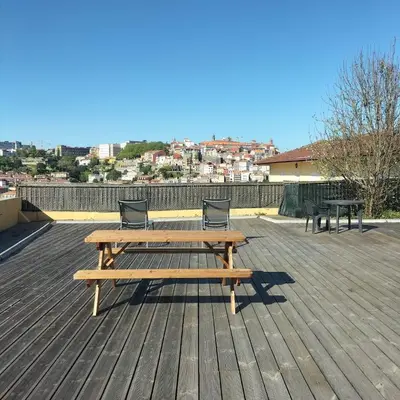 a wooden picnic table and two benches on a deck at Douro Villa 3 - Best View in Town in Vila Nova de Gaia