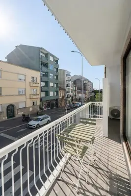 a balcony with a table and chairs on a building at Urban Terrace & Stylish Living Spaces by HostWise in Porto