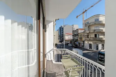 a balcony with chairs and a view of a street at Urban Terrace & Stylish Living Spaces by HostWise in Porto