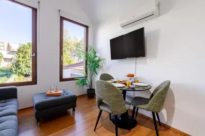 a living room with a table and chairs and a tv at Modern & Cozy Studio by HostWise in Porto