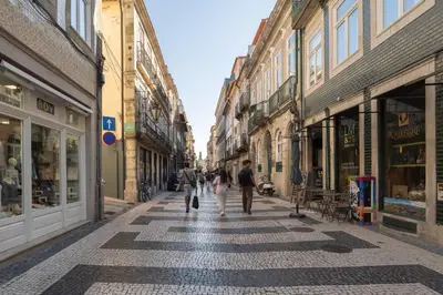 a group of people walking down a street at Modern & Cozy Studio by HostWise in Porto