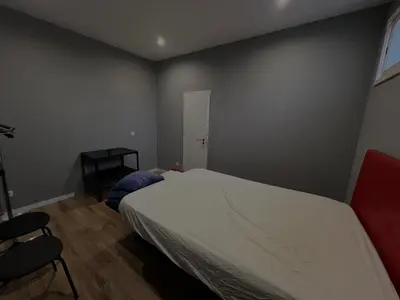 a bedroom with a white bed and a chair at Casa Carvalho Guest House Porto in Porto