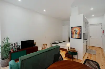 a living room with a couch and a bedroom at Sun Charming Apartment in Porto