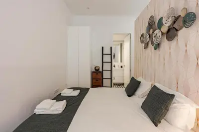 a bedroom with a large white bed with two pillows at Sun Charming Apartment in Porto