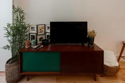 a flat screen tv sitting on top of a cabinet at Sun Charming Apartment in Porto
