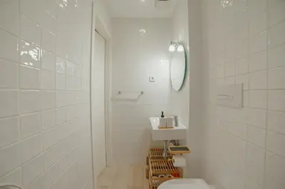 a bathroom with a door leading to a shower at Duque & Company Apartment by Vacationy in Porto