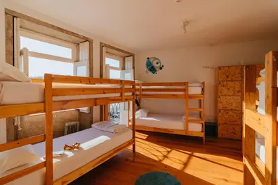 a room with two bunk beds and a window at Happy Porto Hostel in Porto