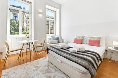 a bedroom with a bed with two towels on it at Noa Porto by Bom Porto Apartments in Porto