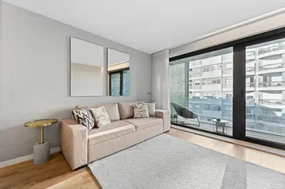 a living room with a couch and a large window at GuestReady – City Center Apartment with Balcony in Porto