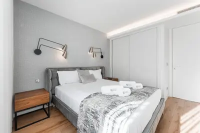 a bedroom with a bed with two towels on it at GuestReady – City Center Apartment with Balcony in Porto