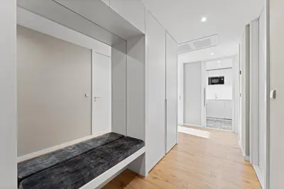 a hallway with a bench in a white wall at GuestReady – City Center Apartment with Balcony in Porto