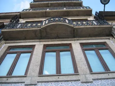 a building with four windows on the side of it at Pinho Apartments, Studios and Rooms in Porto