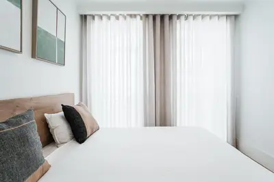 a bedroom with a white bed and a window at Stylish Retreat in Central Porto Stay with Parking in Porto