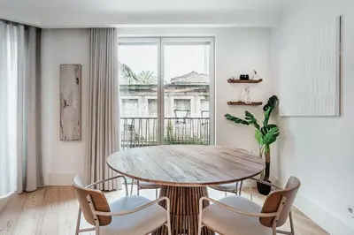 a dining room with a table and chairs and a window at Stylish Retreat in Central Porto Stay with Parking in Porto