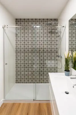 a bathroom with a shower and a white sink at Open-Plan Apartment in Downtown Porto by HostWise in Porto