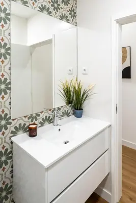 a bathroom with a white sink and a mirror at Open-Plan Apartment in Downtown Porto by HostWise in Porto