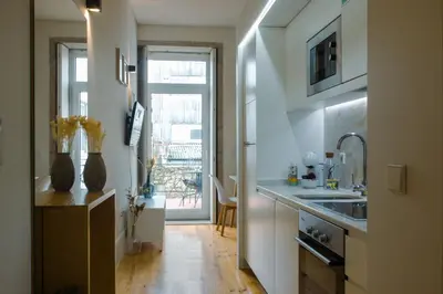 a kitchen with a sink and a counter top at Belas Artes Apartments in Porto