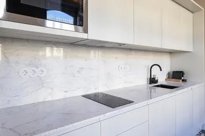a white kitchen with a sink and a microwave at ApartmentsPorto - Alexandre Braga in Porto