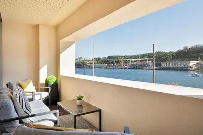 a living room with a view of the water at Ouro Views to Douro River in Porto