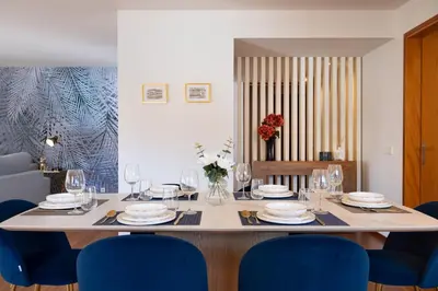 a dining room table with blue chairs and a table with glasses at Ouro Views to Douro River in Porto