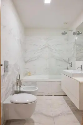 a white bathroom with a tub and a toilet and a sink at Ouro Views to Douro River in Porto