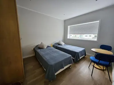 a kitchen and living room with a table and a mirror at Boavista Family T3 in Porto