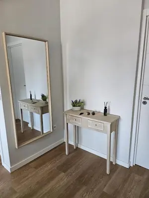 a bathroom with a dressing table and a mirror at Boavista Family T3 in Porto