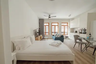a bedroom with a bed and a living room at Downtown Comfort Apartment by Vacationy in Porto