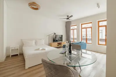 a living room with a bed and a glass table at Downtown Comfort Apartment by Vacationy in Porto