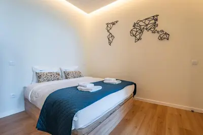 a red door in a room with a floor at Castelões Tiles Studio With Terrace in Porto