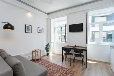 a living room with a couch and a table at Your Base Porto Art District in Porto