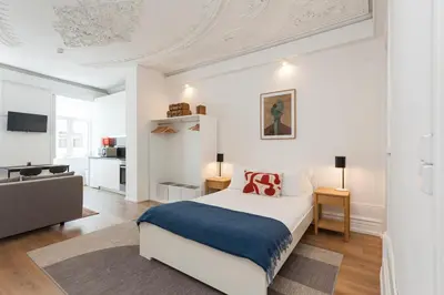 a bedroom with a bed and a living room at Your Base Porto Art District in Porto