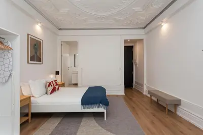 a bedroom with a white bed and a coffered ceiling at Your Base Porto Art District in Porto