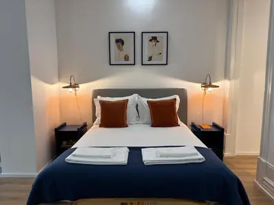 a bedroom with a bed with two towels on it at Your Base Porto Art District in Porto