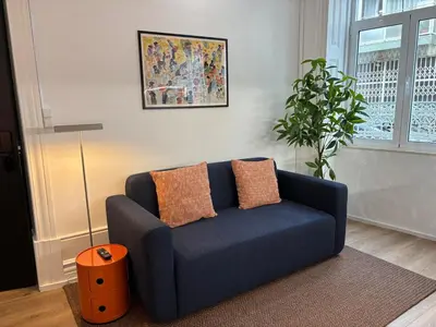 a blue couch in a living room with a plant at Your Base Porto Art District in Porto