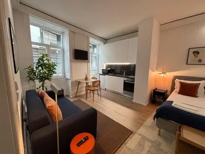 a living room with a couch and a bed at Your Base Porto Art District in Porto